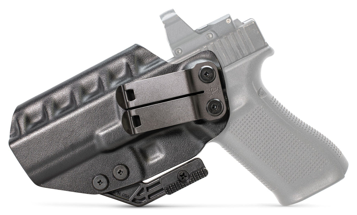The Glock 17 IWB Holster | RIDGE IWB, a black polymer holster with a metal clip, is displayed on a white surface with a translucent grey handgun partially visible in the background.